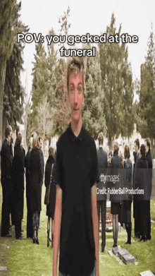 a man is standing in front of a crowd at a funeral