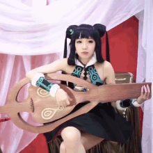 a woman in a costume is holding a guitar with a circle on it