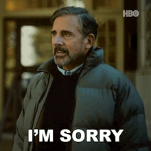 a man in a jacket says i 'm sorry on a screen