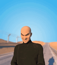 a bald man with a smile on his face is wearing a black shirt