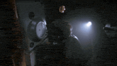 a man wearing headphones is looking at a clock that shows a time of 1:35