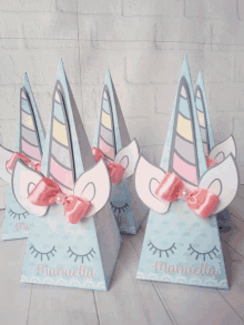 three boxes with unicorn horns and ears with the name manuella written on them