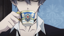 a man drinking from a cup with a red cross on it