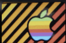 a colorful apple logo on a yellow and orange striped background