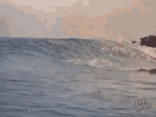 a surfer is riding a wave in the ocean .