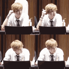 a young man in a white shirt and tie sits at a table with a bottle of water in front of him