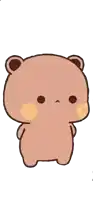 a brown teddy bear with a yellow cheek is standing on a white background and looking at the camera .