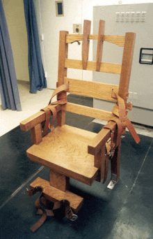 a wooden chair in a room with a light switch on the wall