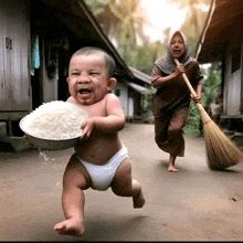 a baby in a diaper is running with a bowl of rice while a woman holds a broom