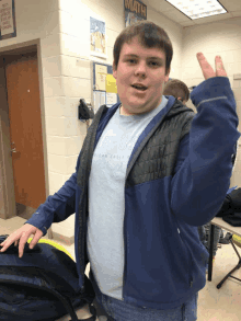 a boy giving a peace sign in front of a math sign