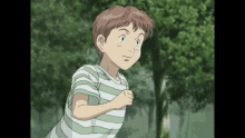 a boy in a green and white striped shirt is running in a forest