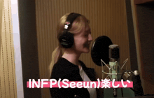 a woman wearing headphones is singing into a microphone with the words infp ( seeun ) written in pink