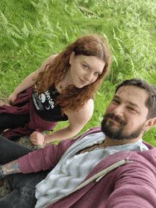 a man and a woman are posing for a picture and the woman is wearing a shirt that says ' fairy tales '