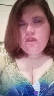 a woman making a funny face with her eyes closed and her mouth open