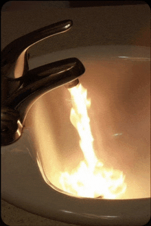 a faucet with flames coming out of it is in a sink