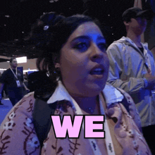 a woman wearing a lanyard that says we