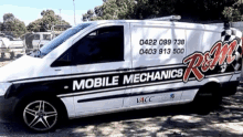 a white van that says mobile mechanics is parked in a parking lot