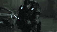 a man in a military uniform is holding a gun with a blue light on it