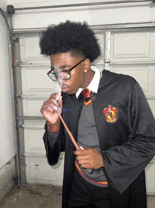 a man in a gryffindor costume is smoking a cigarette