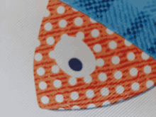 a piece of fabric with polka dots and a bear face