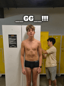 a man in underwear stands in front of a locker with a sign that says nc fit