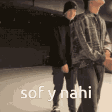 a couple of men standing next to each other with the words sof y nahi written on the bottom