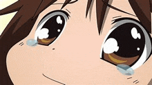 a close up of a cartoon girl 's eyes with tears running down them .