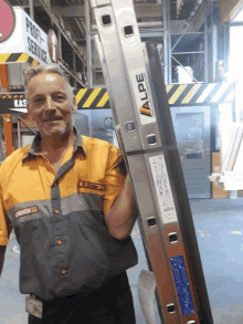 a man holding a ladder that has the word valpe on it