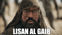 a man with glasses and a beard is wearing a scarf around his head and says lisan al gaib