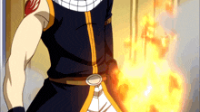 a man in a black and orange outfit is holding a flame in his hand