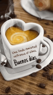 a cup of coffee in the shape of a heart is on a saucer .