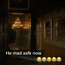 a man in a white tuxedo is standing in a hallway with the words he mad asfk now above him