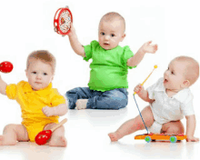 three babies are playing with musical instruments including a tambourine xylophone and maracas