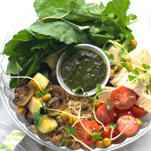 a salad in a plastic container with a dipping sauce in the middle