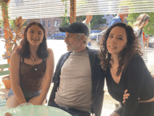 a man and two women are posing for a picture together