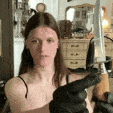 a woman is holding a knife with a wooden handle in her hand .