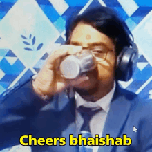 a man in a suit and tie is drinking from a cup and says cheers bhaishab