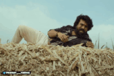 a man laying on top of a pile of hay with the name pranay_varma below him