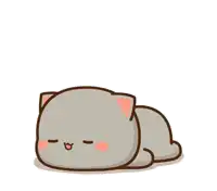 a white cat is standing next to a gray cat laying on the floor .