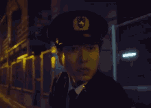 a police officer is talking on a walkie talkie in a dark street .