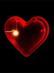 a red heart with a light shining through it