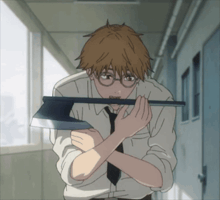 a man with glasses is holding a large axe in his hands