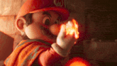 a cartoon character named mario is holding a flame in his hand