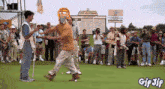 a group of people standing on a golf course with a sign that says at & t national on it