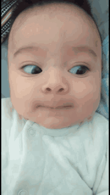 a close up of a baby making a face