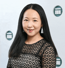 a woman wearing a black lace top with a pattern of circles