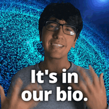 a man with glasses says " it 's in our bio " in front of a blue background
