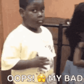 a young boy is making a funny face with the words oops my bad above him