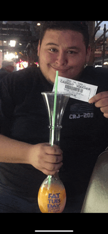 a man holding a glass with a straw and a ticket that says cashout voucher crj-200