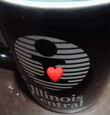 a coffee mug that says illinois central with a red heart on it